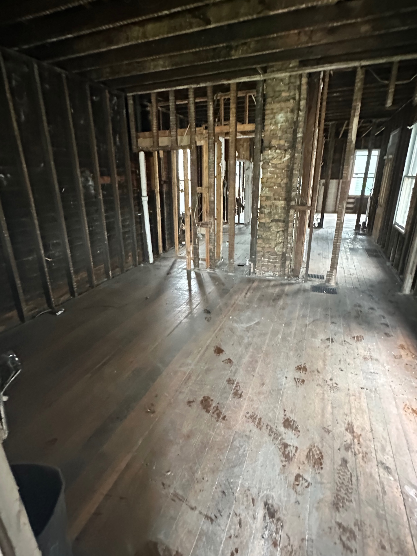 Same space after demolition, stripped to the studs
