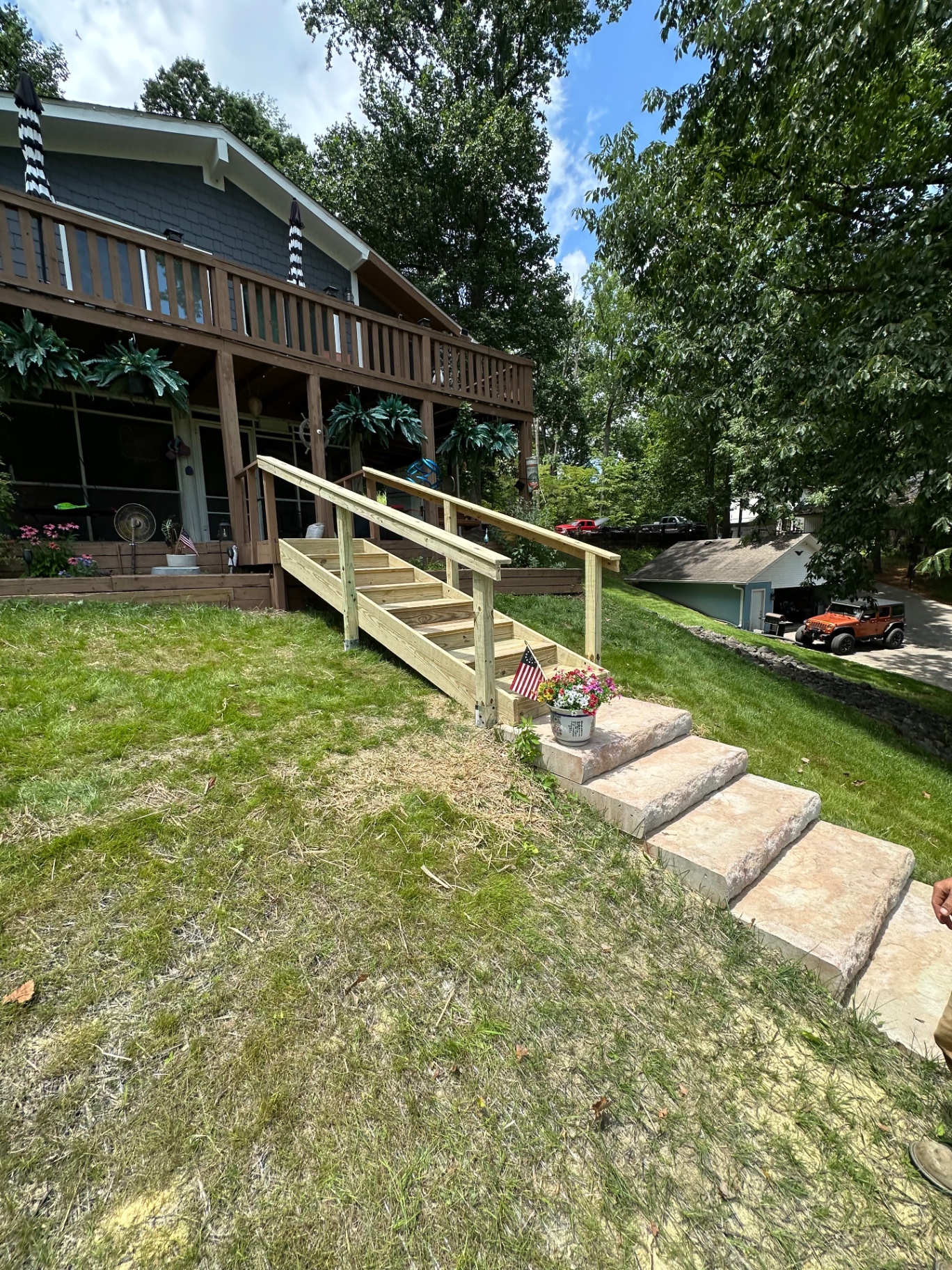 New pressure-treated stairs and handrail with stone landing