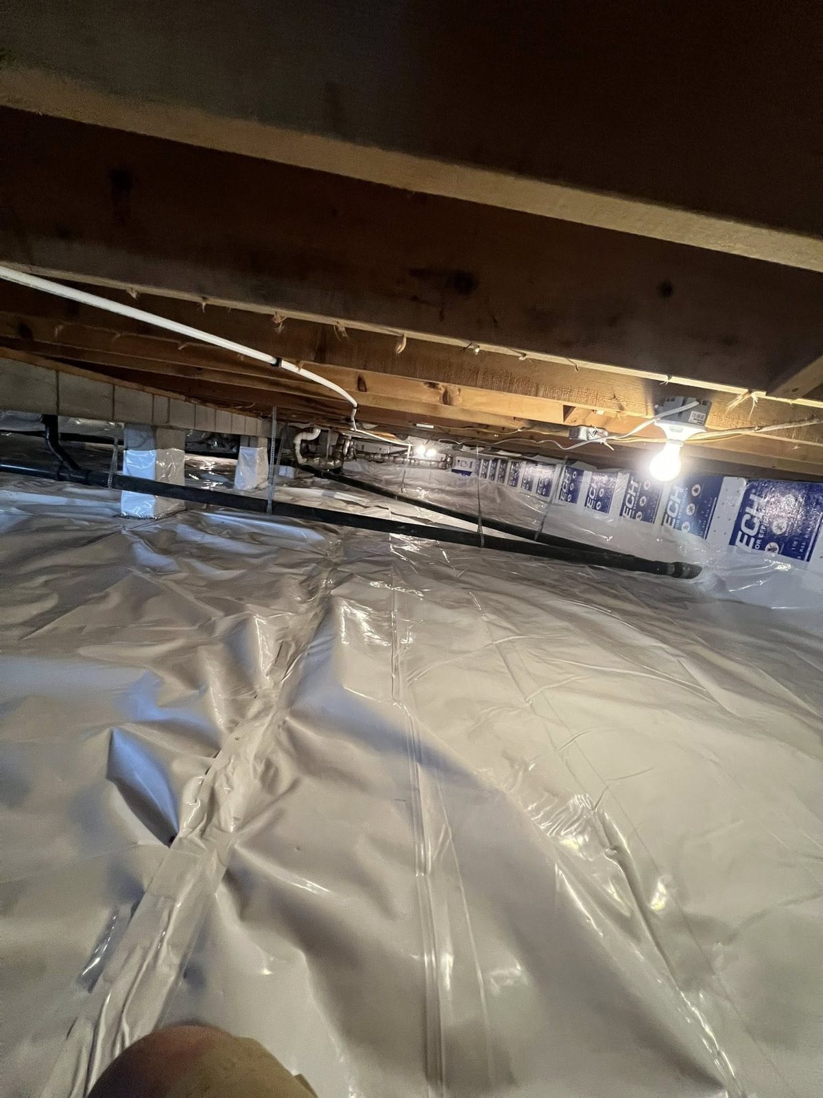 Crawl space vapor barrier installation